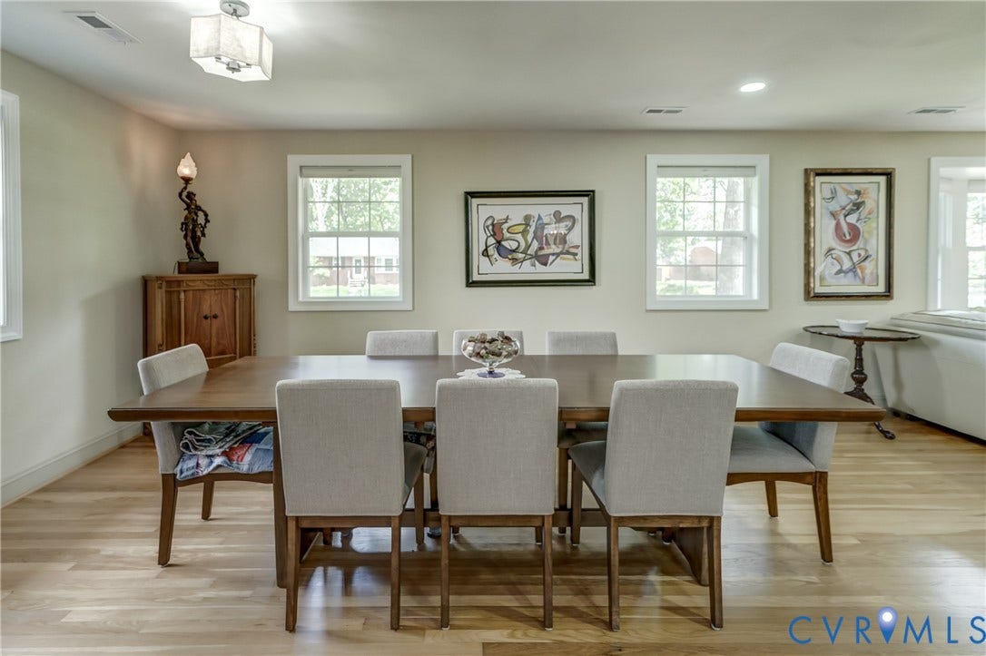 Hardwood flooring throughout, multiple windows, recessed lighting, and a surface-mounted light fixture