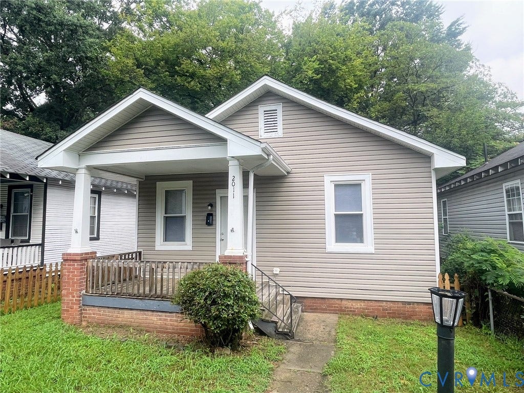 Light gray vinyl siding exterior with white trim accents