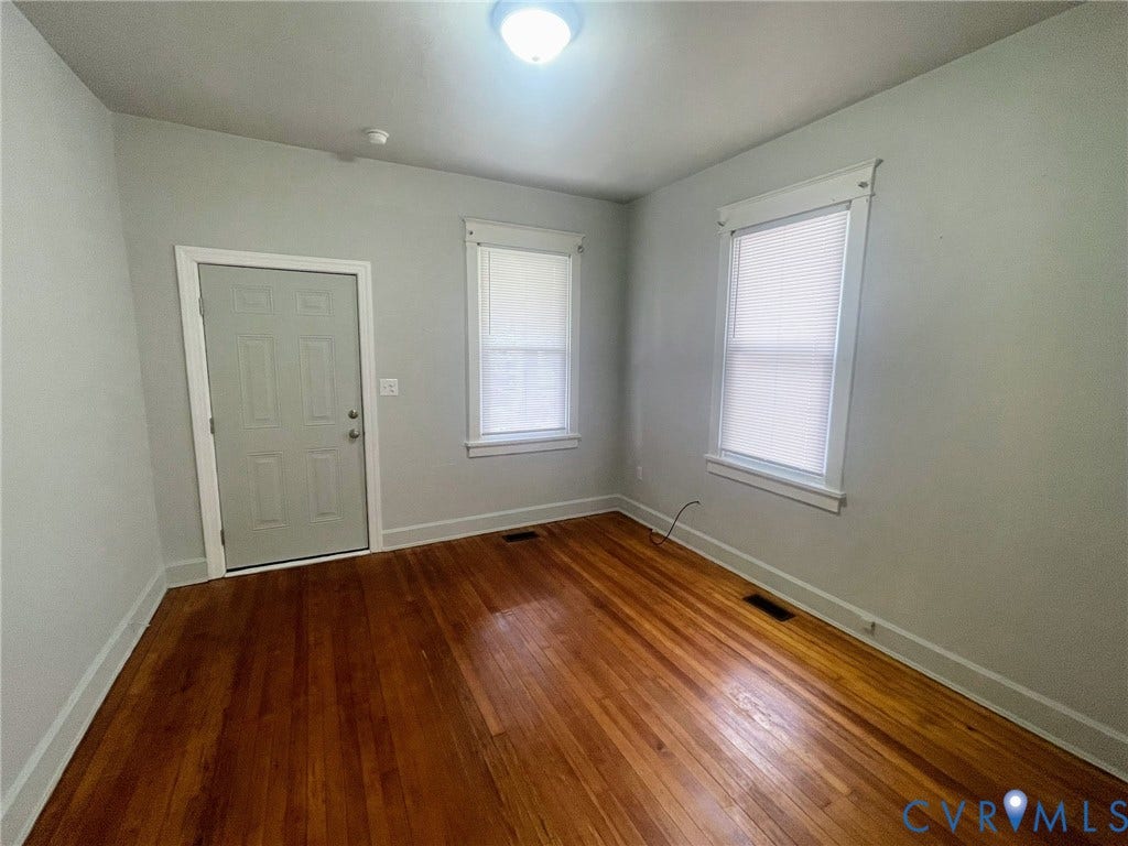 Hardwood flooring throughout, complemented by light-toned walls