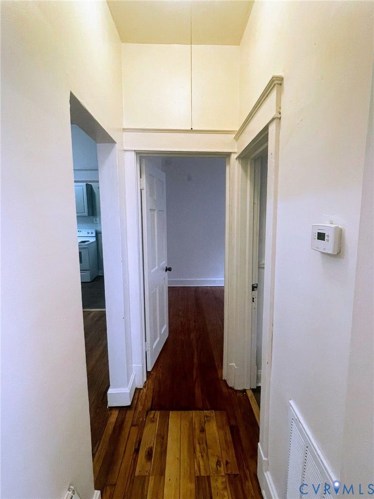 Hardwood-finish flooring throughout, featuring crisp white trim and solid interior doors