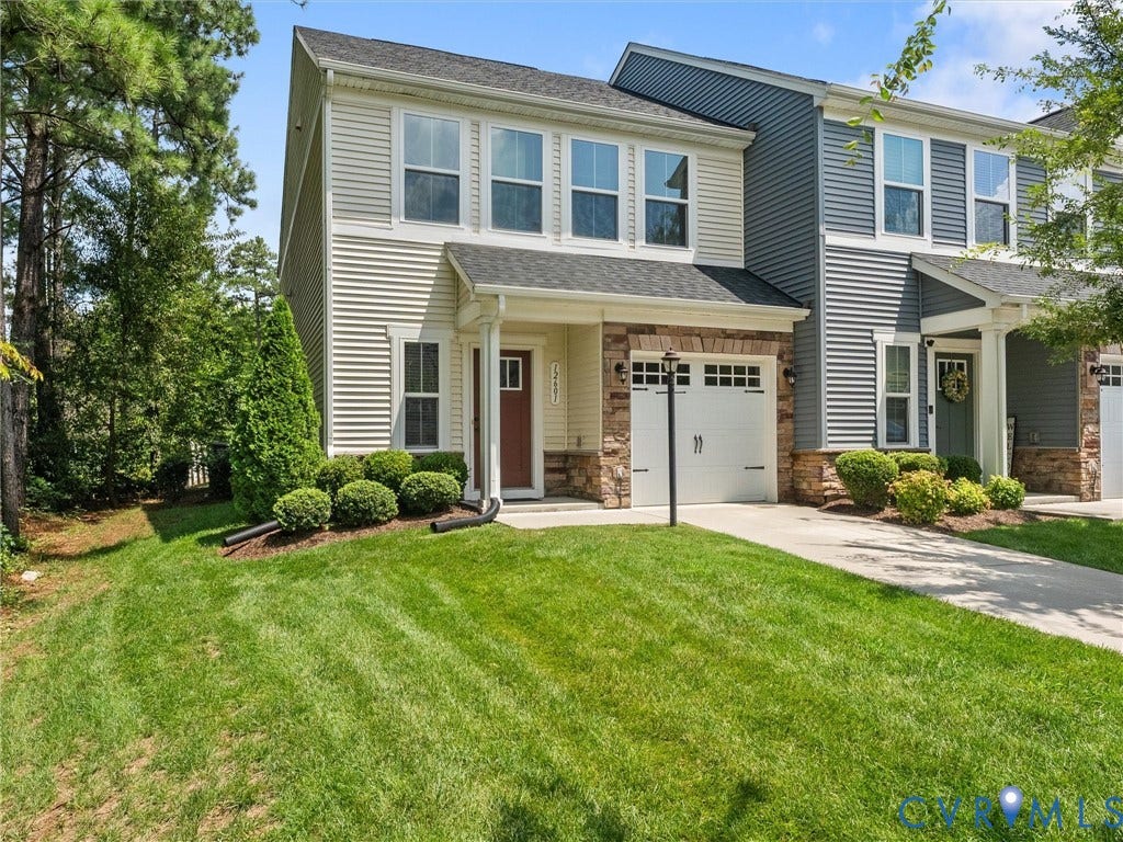 12601 Prestonfield Drive, Blalock, Chesterfield, VA 23836 Two-story exterior with light-colored siding, contrasting stone veneer accents, and a white paneled garage door
