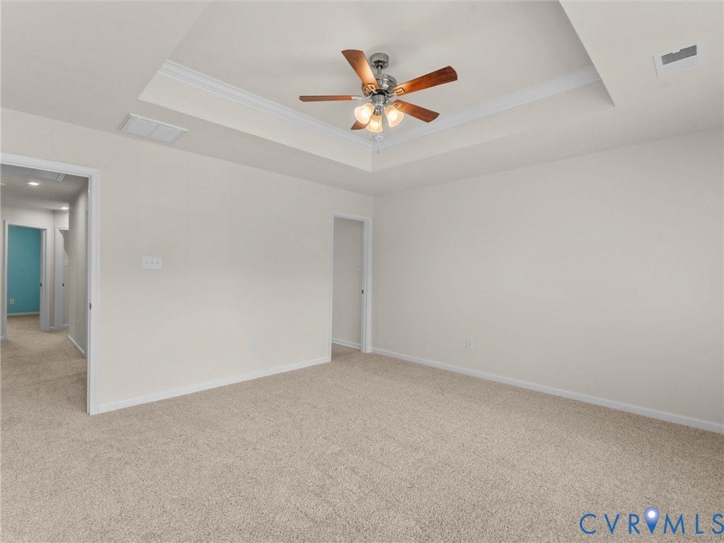 12601 Prestonfield Drive, Blalock, Chesterfield, VA 23836 Tray ceiling with crown molding, ceiling fan with light fixture, neutral carpet, and white walls