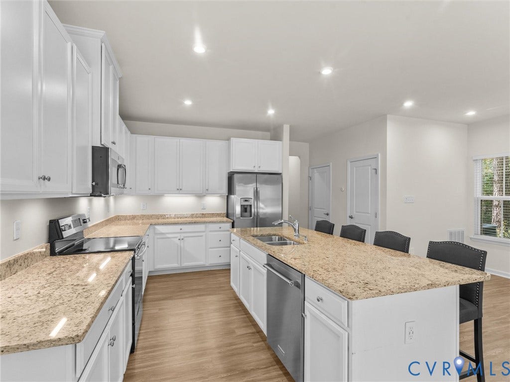 12601 Prestonfield Drive, Blalock, Chesterfield, VA 23836 White cabinetry with silver hardware, light-toned countertops, stainless steel appliances, and wood-finish flooring
