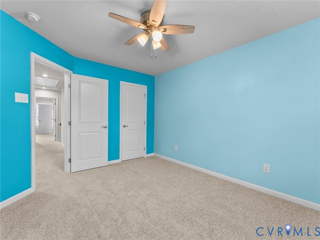12601 Prestonfield Drive, Blalock, Chesterfield, VA 23836 Carpeted room featuring a ceiling fan with integrated lighting, two panel doors, and vibrant wall finishes