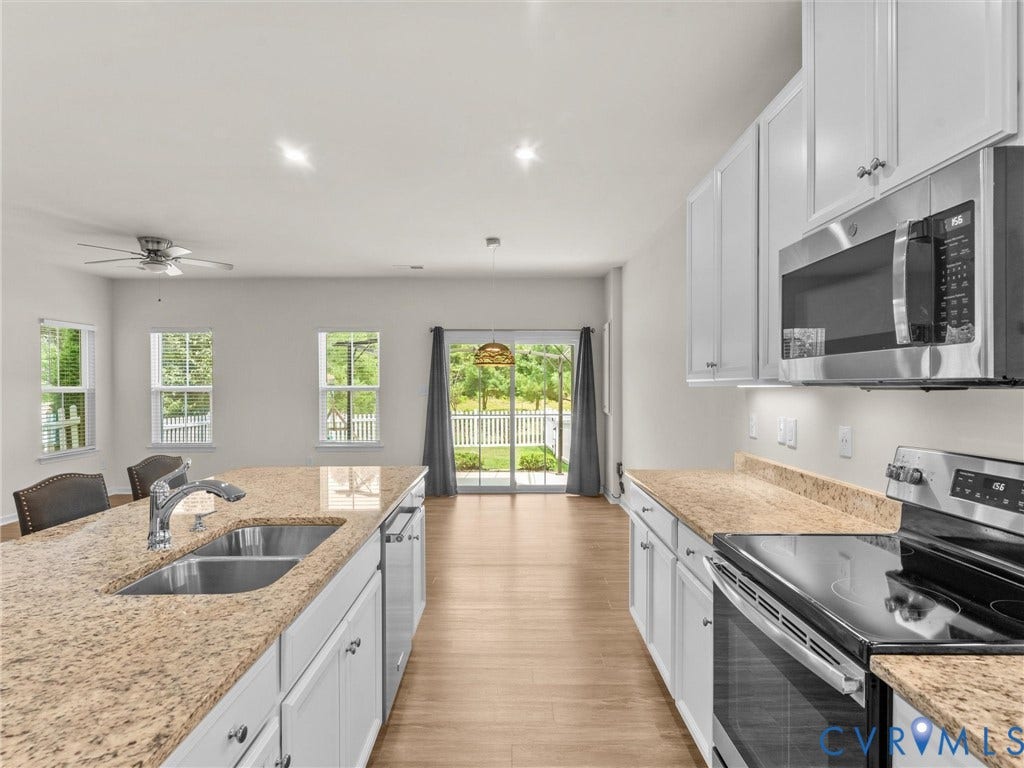 12601 Prestonfield Drive, Blalock, Chesterfield, VA 23836 Kitchen featuring white cabinetry, stainless steel appliances, granite countertops, and wood-finish flooring