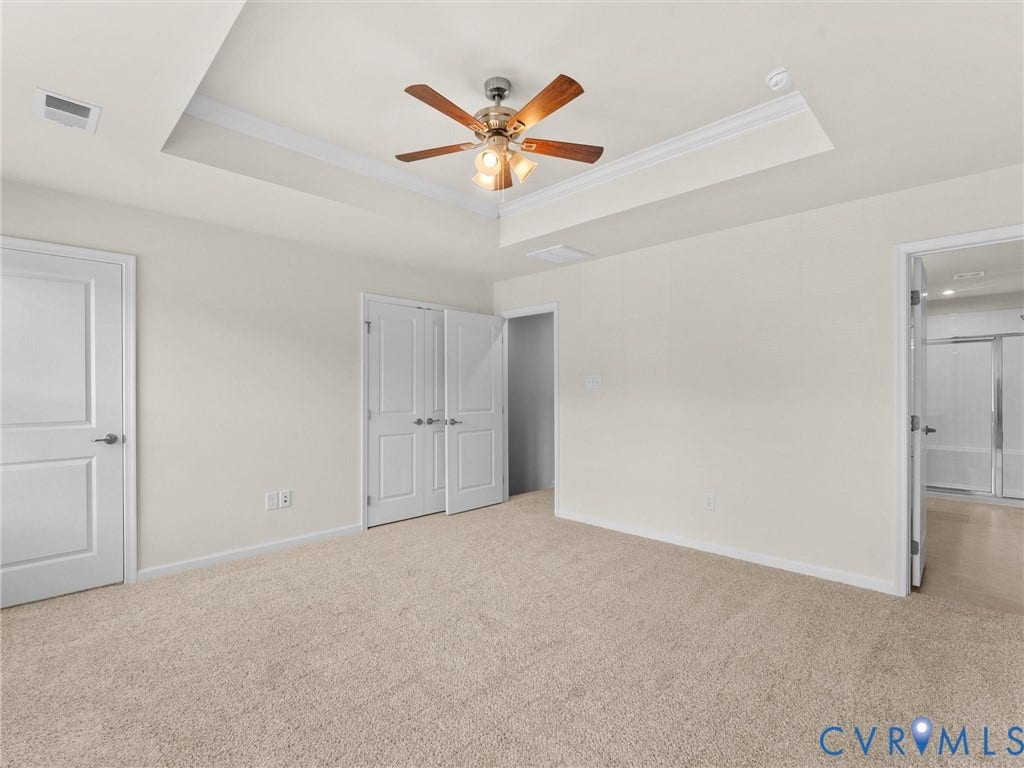 12601 Prestonfield Drive, Blalock, Chesterfield, VA 23836 Tray ceiling with crown molding, ceiling fan with light fixture, neutral carpeting, double closet doors, and painted trim