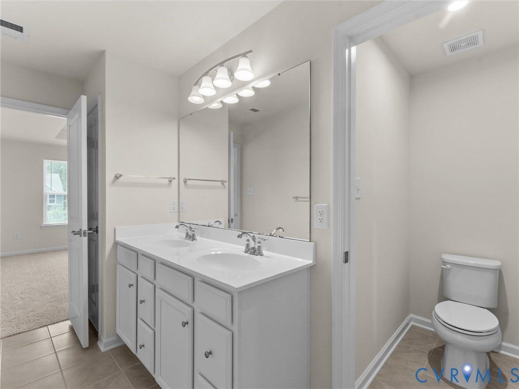 12601 Prestonfield Drive, Blalock, Chesterfield, VA 23836 Dual vanity with white cabinetry, polished chrome fixtures, and a large mirror