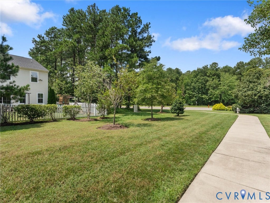 12601 Prestonfield Drive, Blalock, Chesterfield, VA 23836 Expansive lawn with mature trees and a concrete pathway