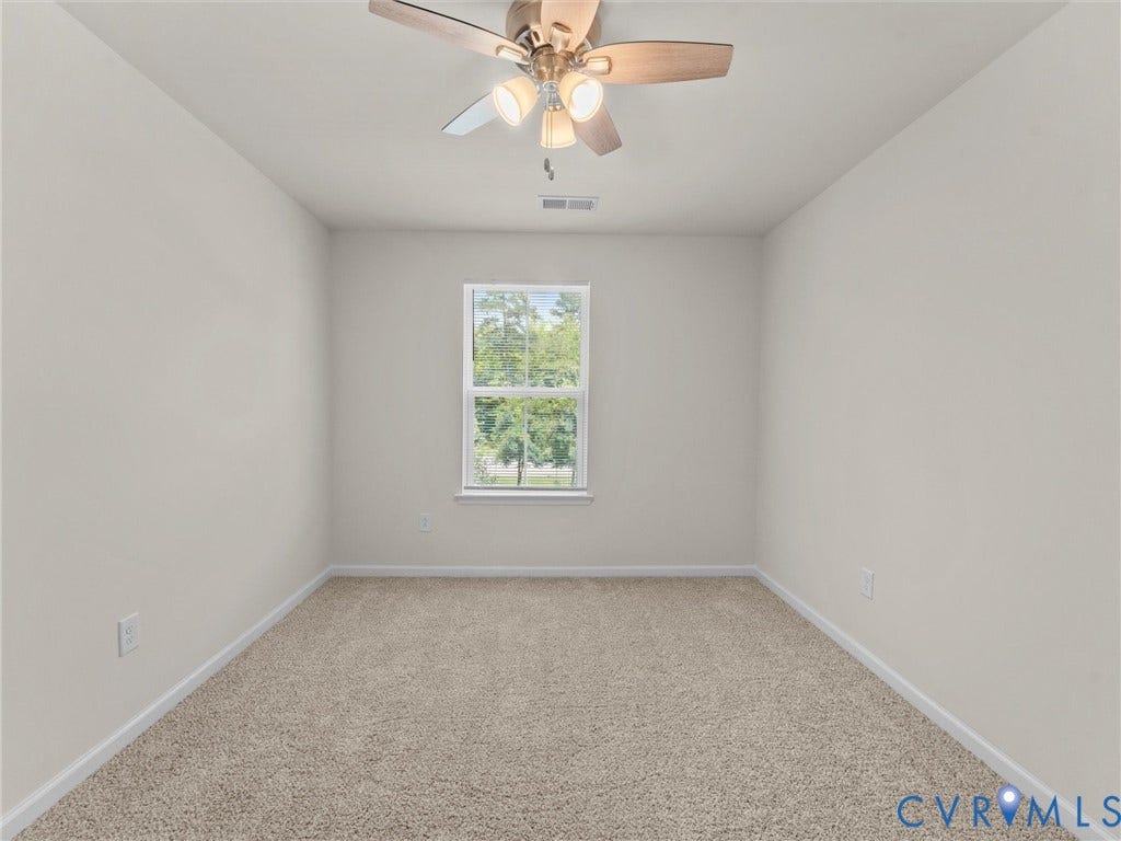 12601 Prestonfield Drive, Blalock, Chesterfield, VA 23836 Neutral tone wall finish, carpet flooring, window with white trim, and a ceiling fan with integrated lighting