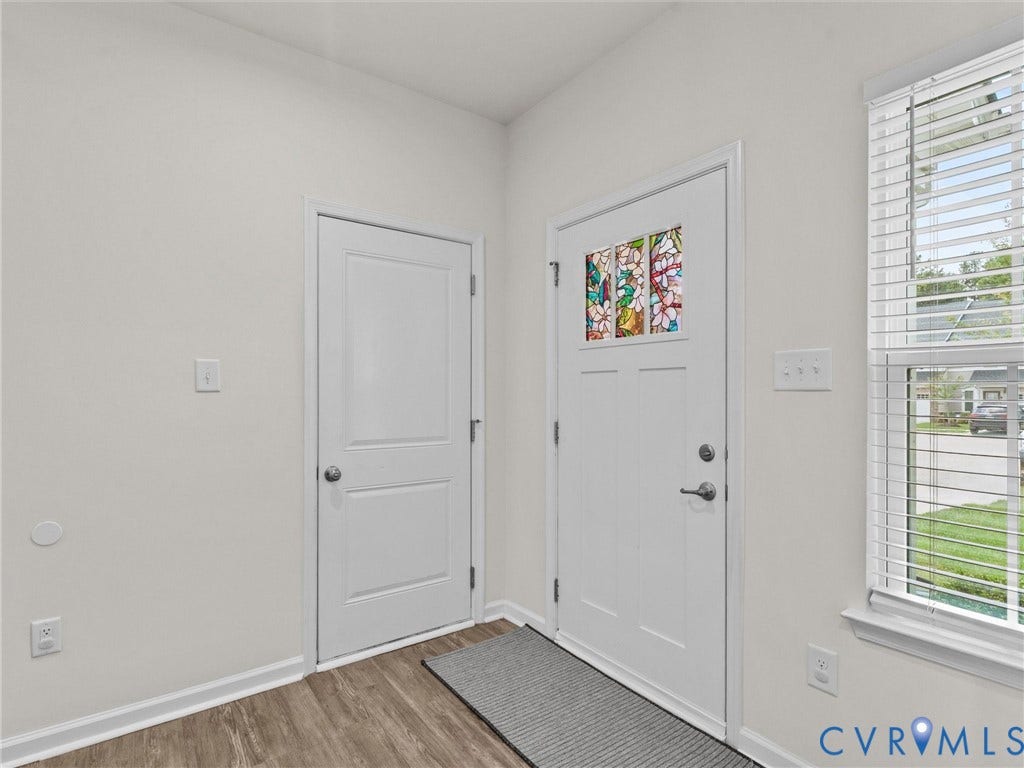 12601 Prestonfield Drive, Blalock, Chesterfield, VA 23836 Entryway featuring a white paneled door with stained glass insert, wood-finish flooring, and a white framed window