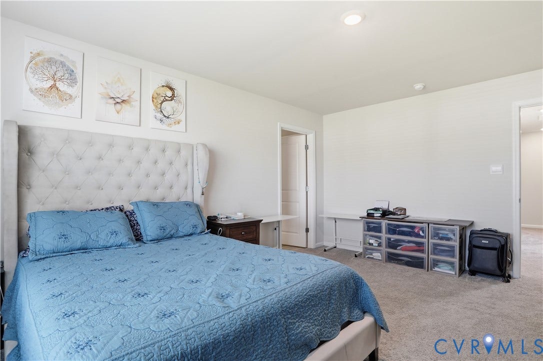 Carpeted room with light-toned walls and recessed lighting