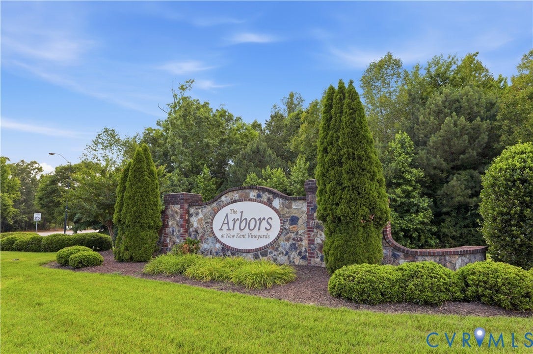 Stone and brick entrance monument with a prominently displayed community name