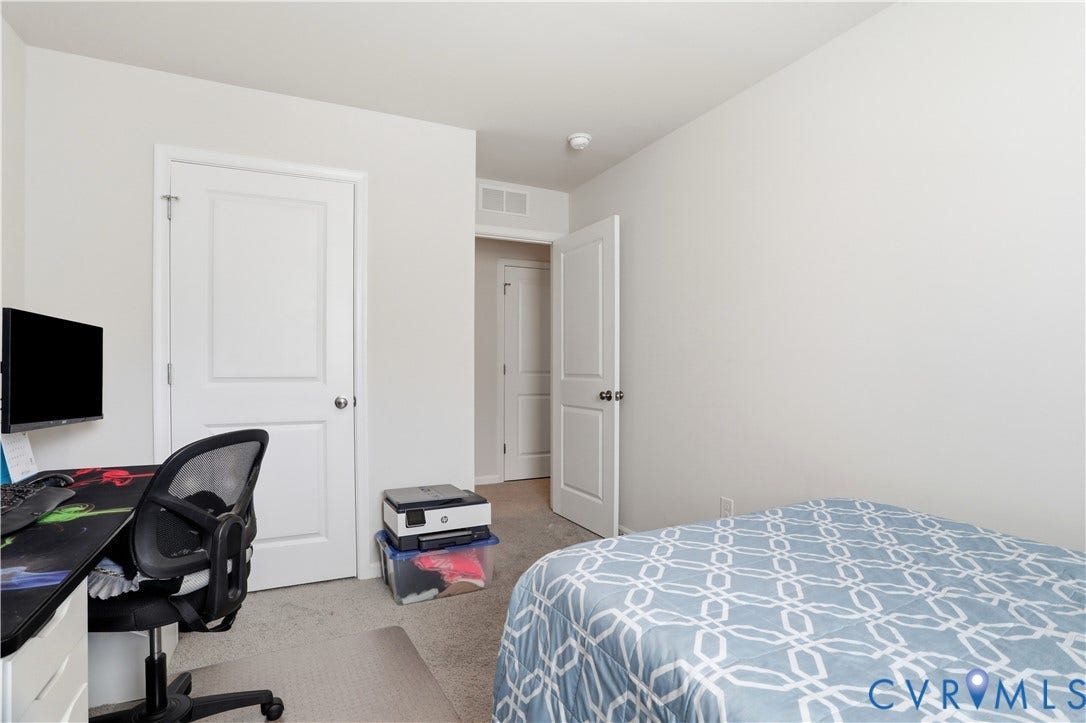 Carpeted room with white walls, a single paneled door, and recessed lighting