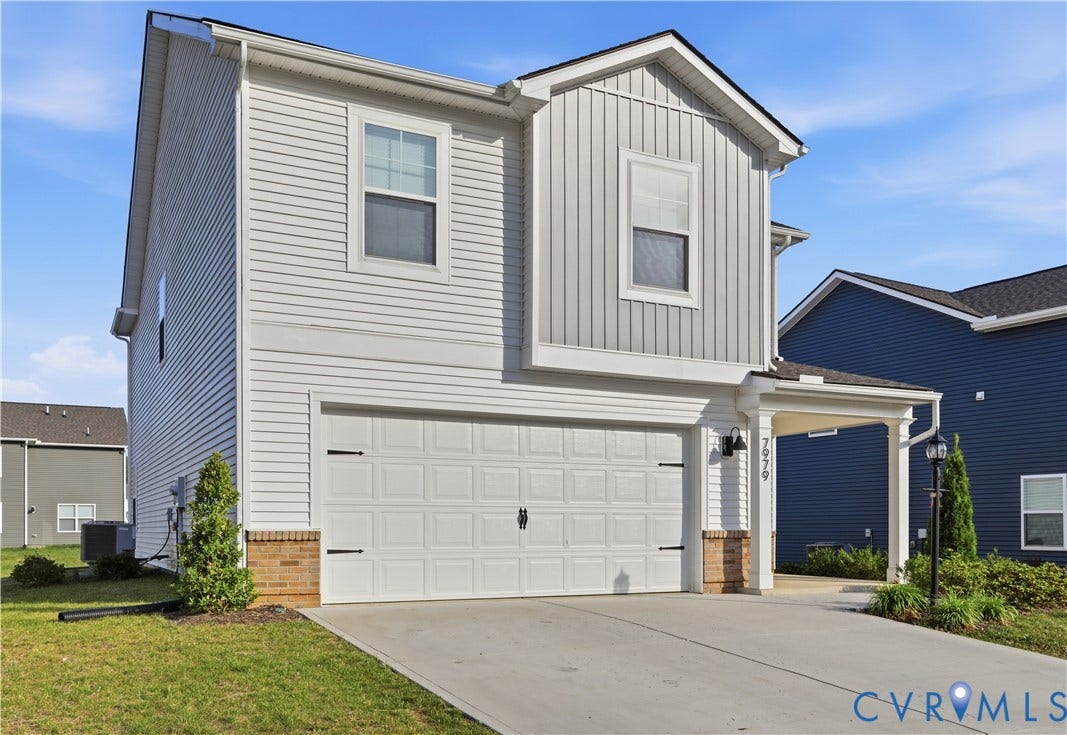 Two-story residence featuring light gray horizontal siding and vertical accent siding