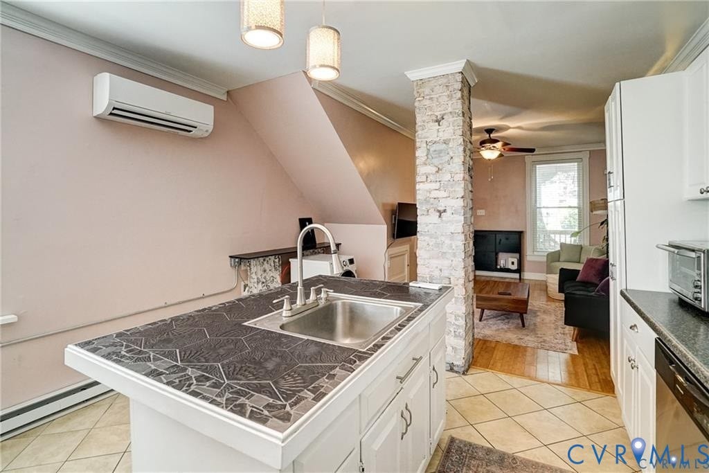 1410 W Clay Street, Richmond, VA 23220 Kitchen with white cabinetry, tile counters, light tile patterned floors, crown molding, and ornate columns