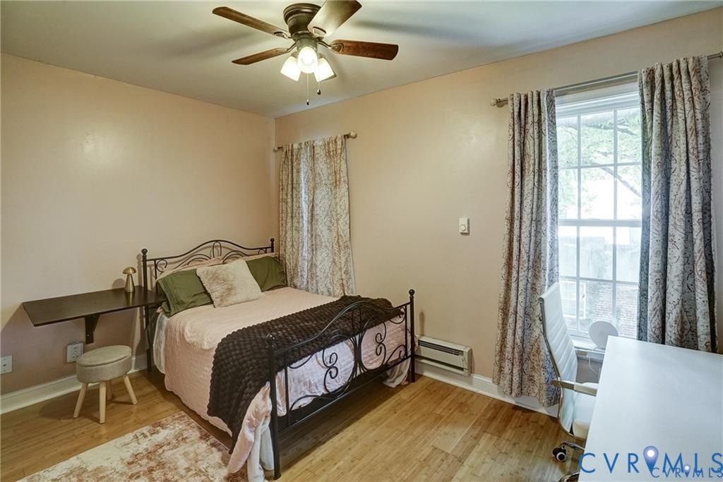 1410 W Clay Street, Richmond, VA 23220 Bedroom featuring light wood-style flooring, a baseboard heating unit, and a ceiling fan