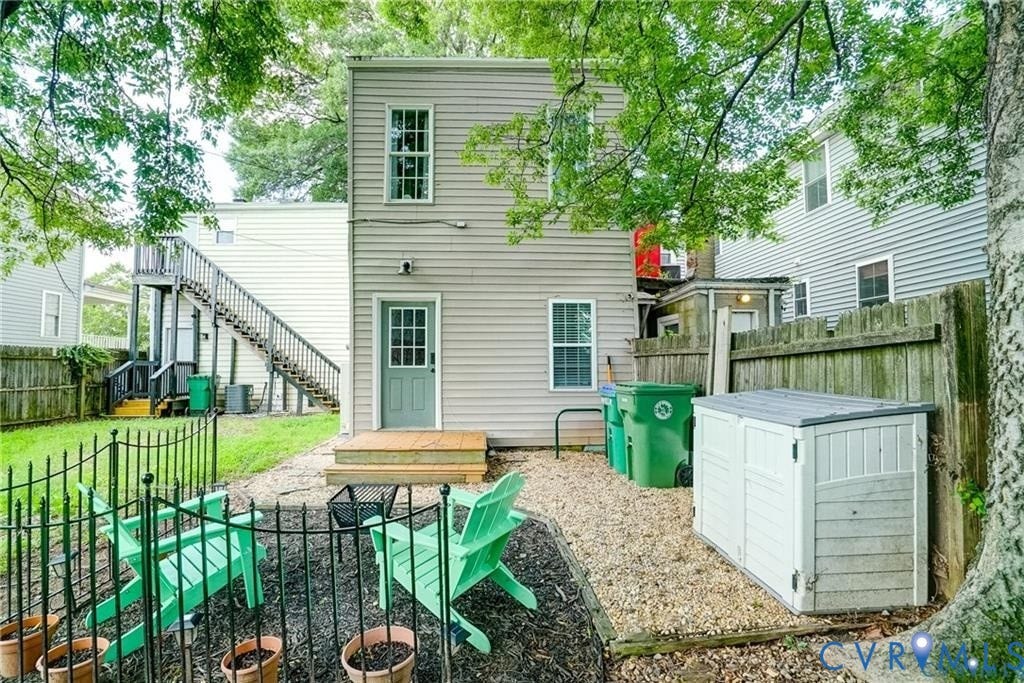 1410 W Clay Street, Richmond, VA 23220 Rear view of house featuring a fenced backyard, a patio area, stairway, and a wooden deck