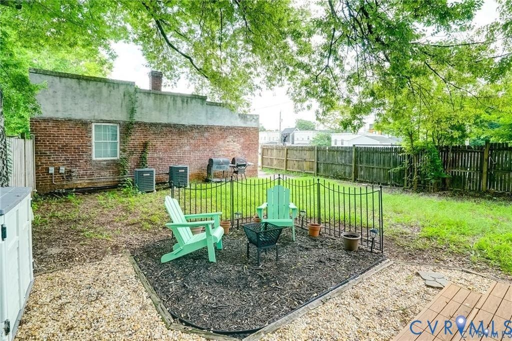 1410 W Clay Street, Richmond, VA 23220 Fenced backyard featuring a patio area and a fire pit