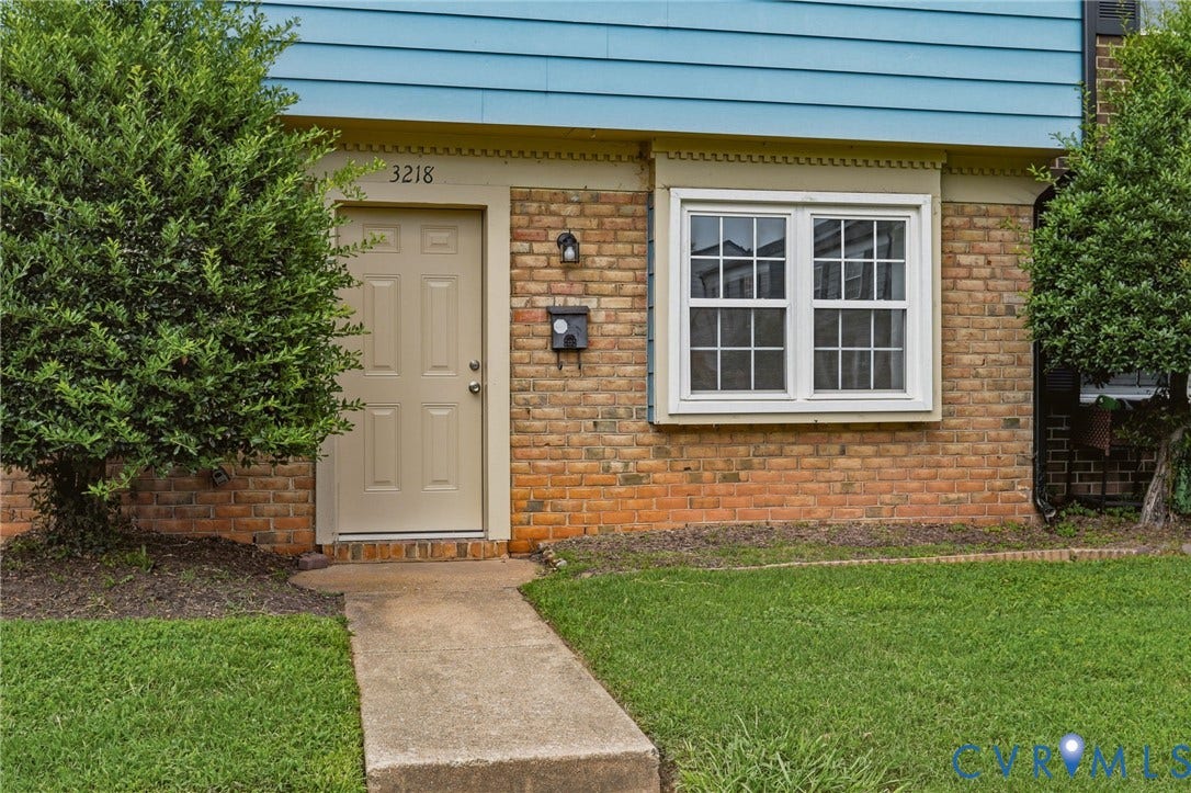 3218 Hunters Mill Court, Henrico, VA 23223 Brick facade with blue siding accent and a paneled entry door