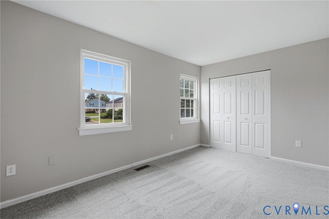 3218 Hunters Mill Court, Henrico, VA 23223 Neutral gray wall paint with white trim, light gray patterned carpeting, double-pane windows, and a bi-fold closet door