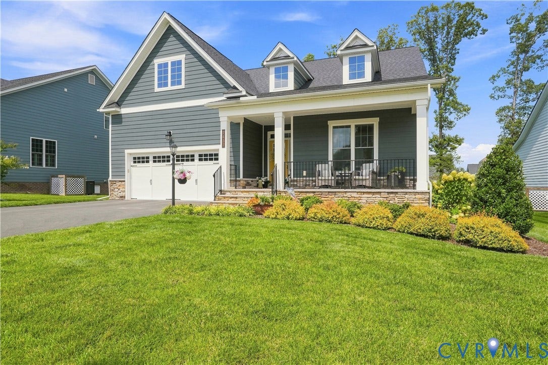 7437 Aldeby Street, Glen Allen, VA 23059 Siding exterior with stone accents, covered front porch, white-trimmed windows, and a two-car garage