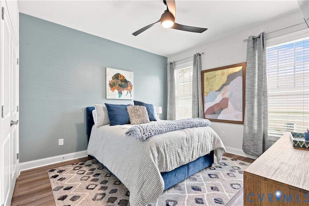7437 Aldeby Street, Glen Allen, VA 23059 Wood-finish flooring, white paneled doors, ceiling fan, and large windows with blinds