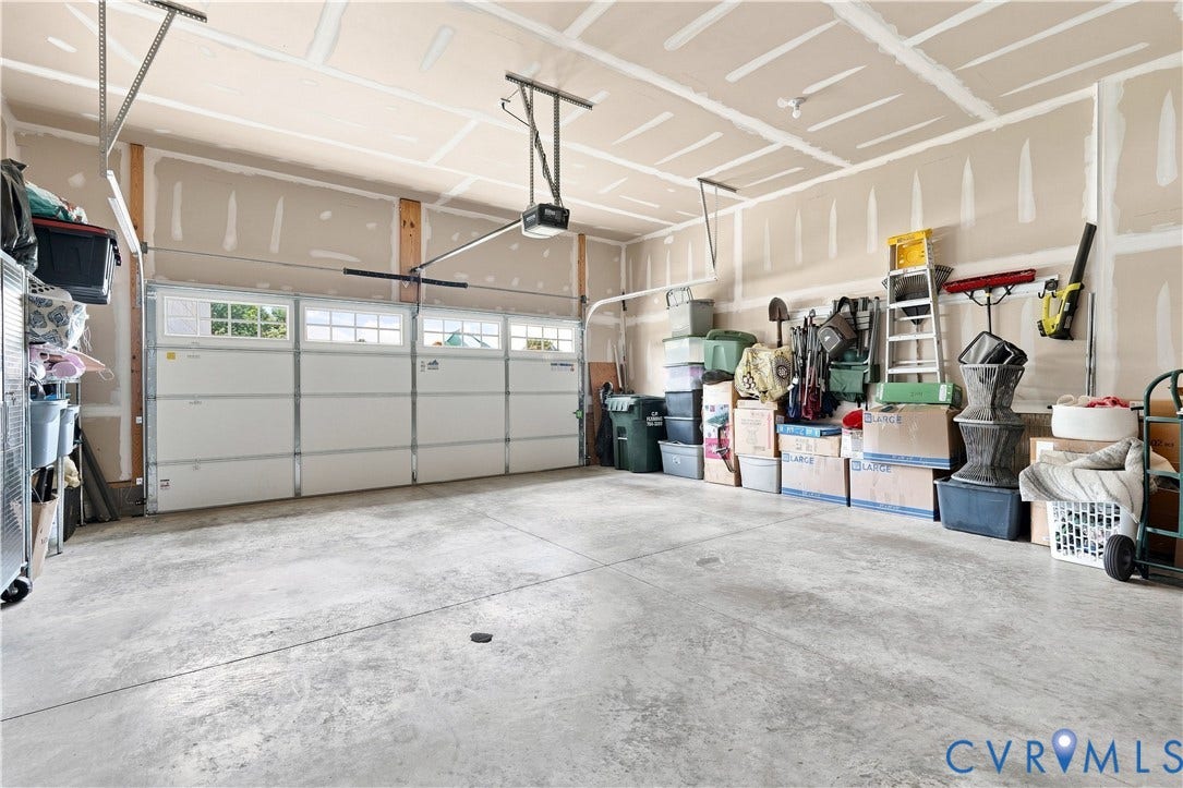 7437 Aldeby Street, Glen Allen, VA 23059 Two-car garage with a concrete floor, an overhead door with transom windows, and an automatic garage door opener