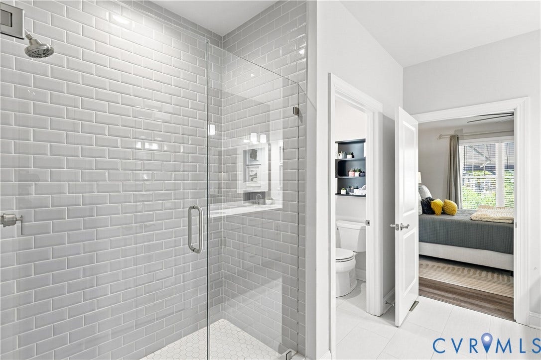 7437 Aldeby Street, Glen Allen, VA 23059 Enclosed shower with subway tile surround, clear glass door, and hexagonal tile flooring