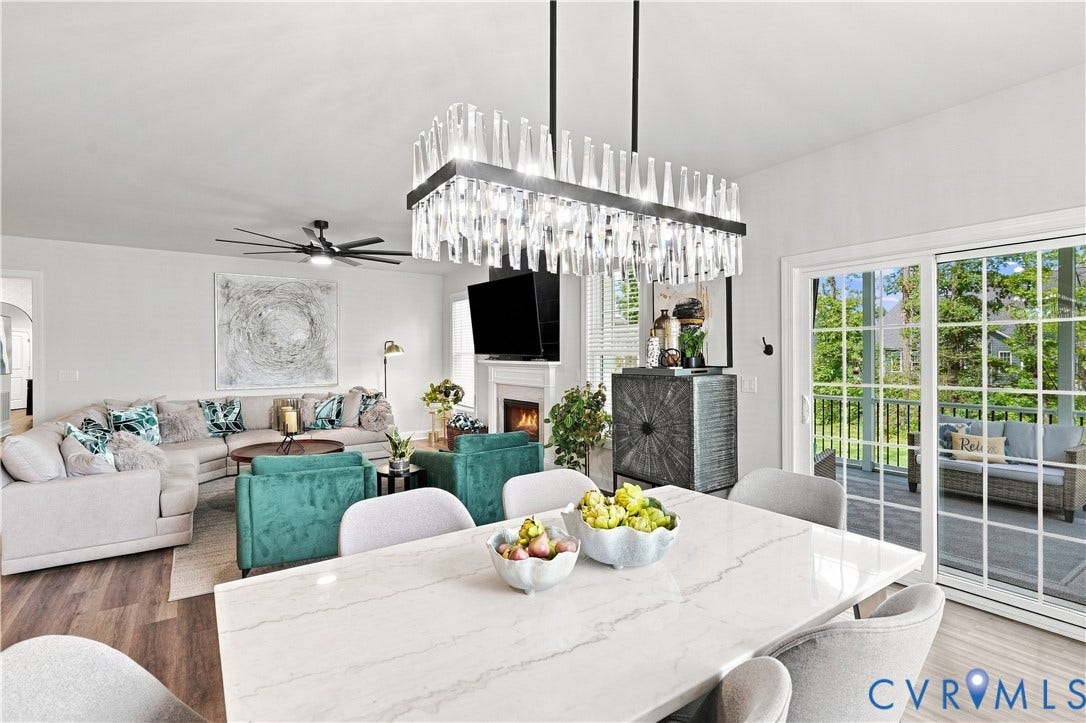7437 Aldeby Street, Glen Allen, VA 23059 Open concept living area featuring a rectangular chandelier, wood-finish flooring, and a fireplace