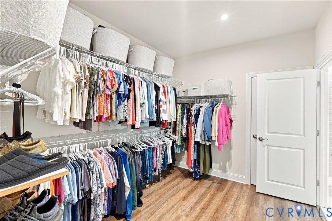 7437 Aldeby Street, Glen Allen, VA 23059 Spacious walk-in closet featuring wood-finish flooring, white wire shelving, recessed ceiling lighting, and a paneled door