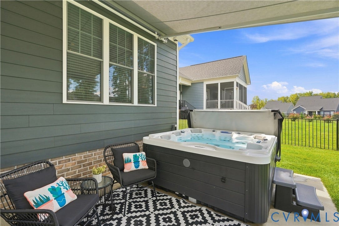 7437 Aldeby Street, Glen Allen, VA 23059 Patio featuring a hot tub/spa, concrete flooring, and a partial brick exterior