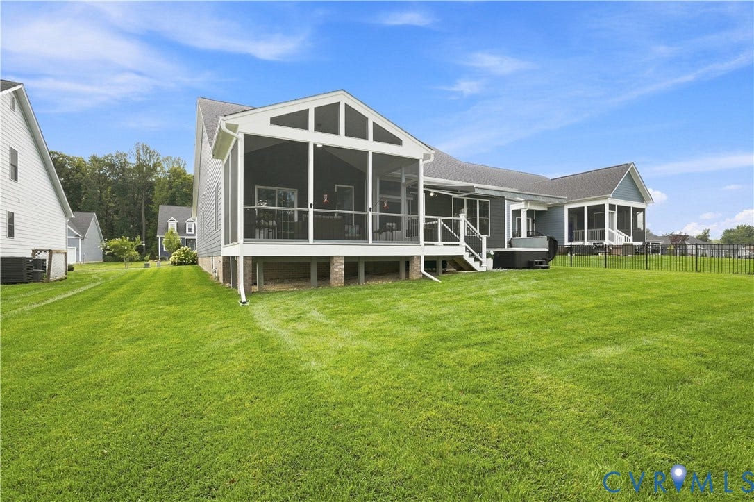 7437 Aldeby Street, Glen Allen, VA 23059 Expansive green lawn with a screened-in porch, additional screened patio, and a privacy fence
