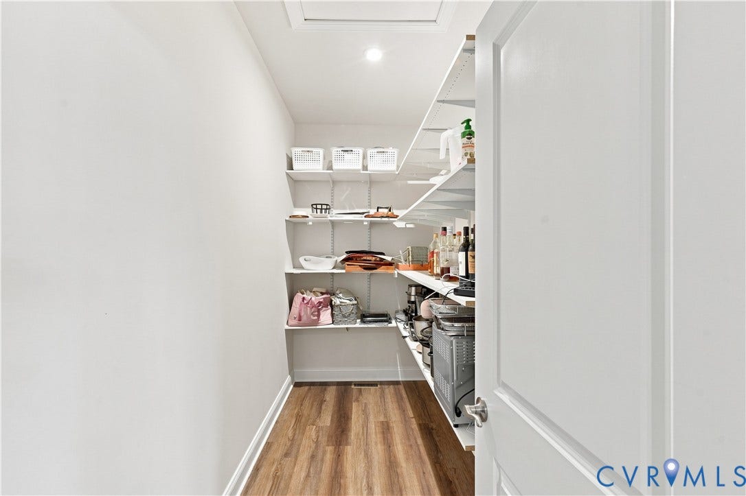 7437 Aldeby Street, Glen Allen, VA 23059 Walk-in pantry featuring extensive shelving, recessed lighting, and wood-finish flooring