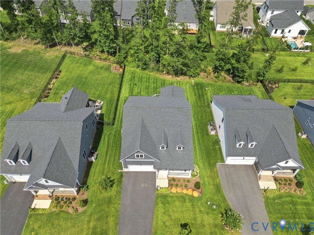 7437 Aldeby Street, Glen Allen, VA 23059 Expansive lot featuring a green lawn, mature trees, and a privacy fence
