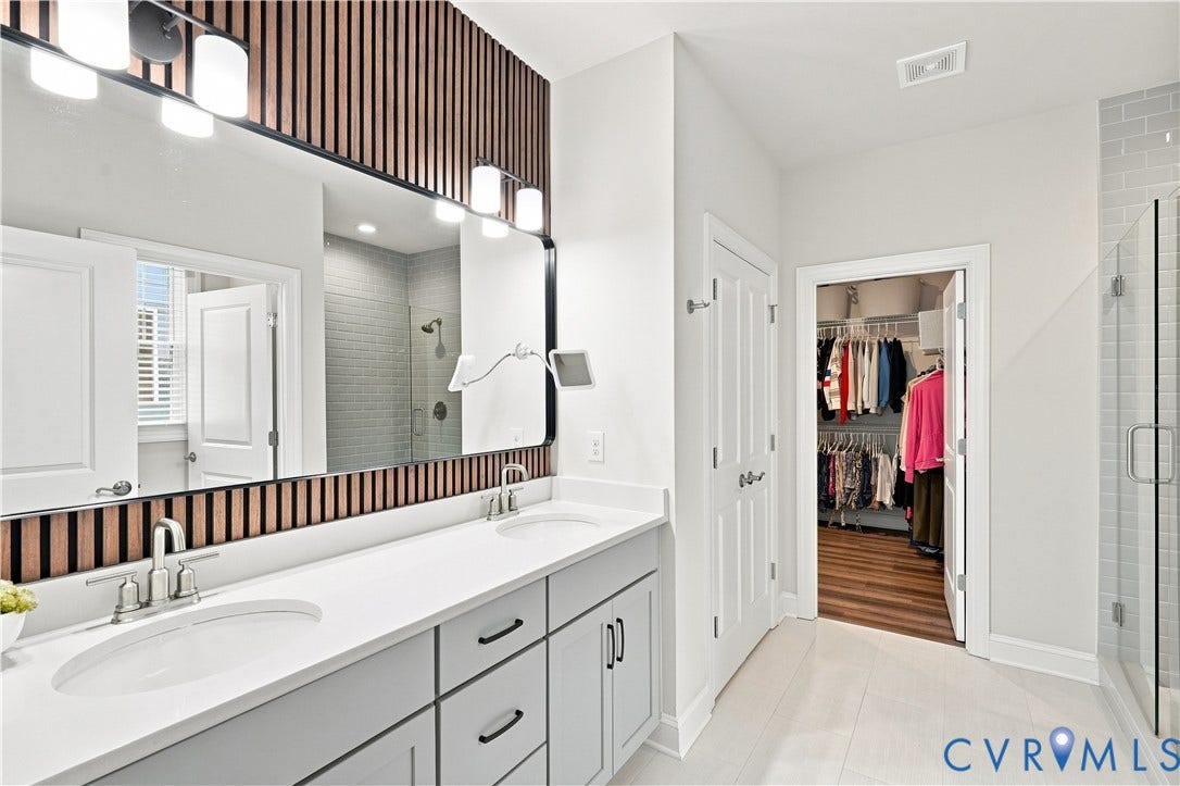 7437 Aldeby Street, Glen Allen, VA 23059 Double vanity with undermount sinks, stone countertops, and modern cabinetry
