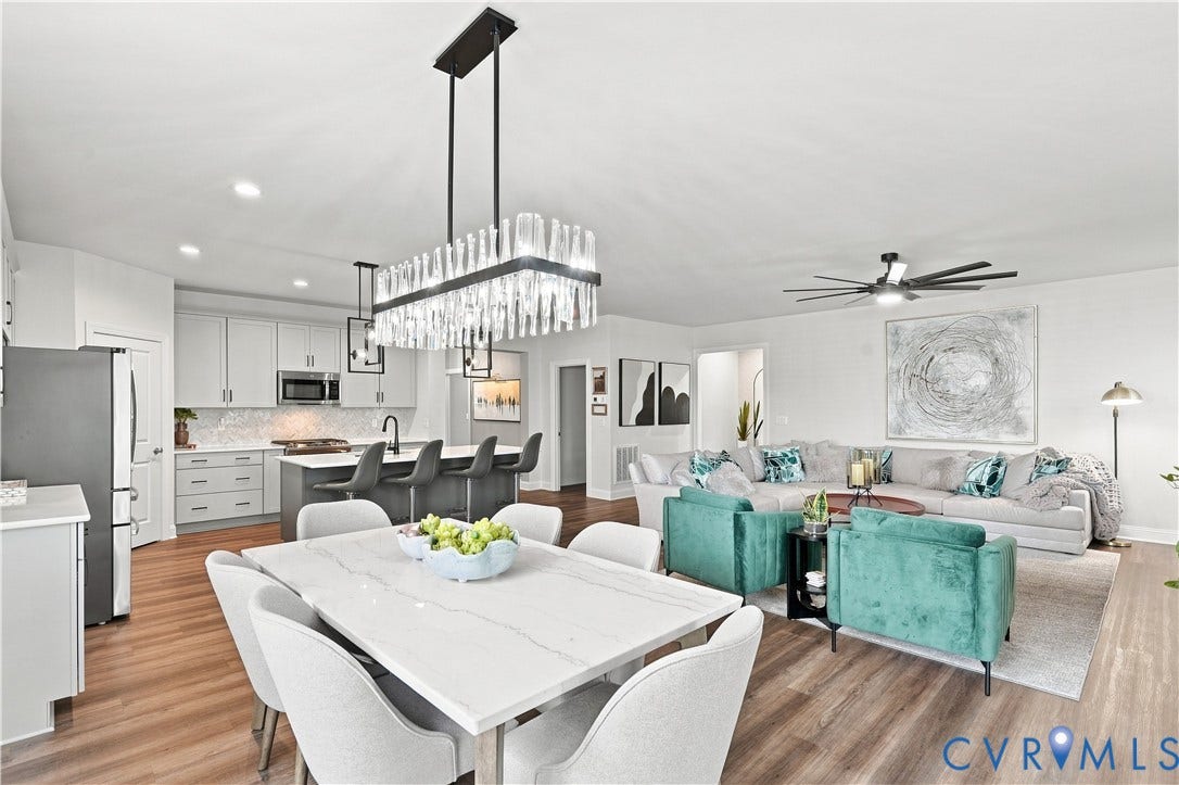 7437 Aldeby Street, Glen Allen, VA 23059 Open-concept living space featuring wood-finish flooring, a modern linear chandelier, recessed lighting, and a kitchen island with seating