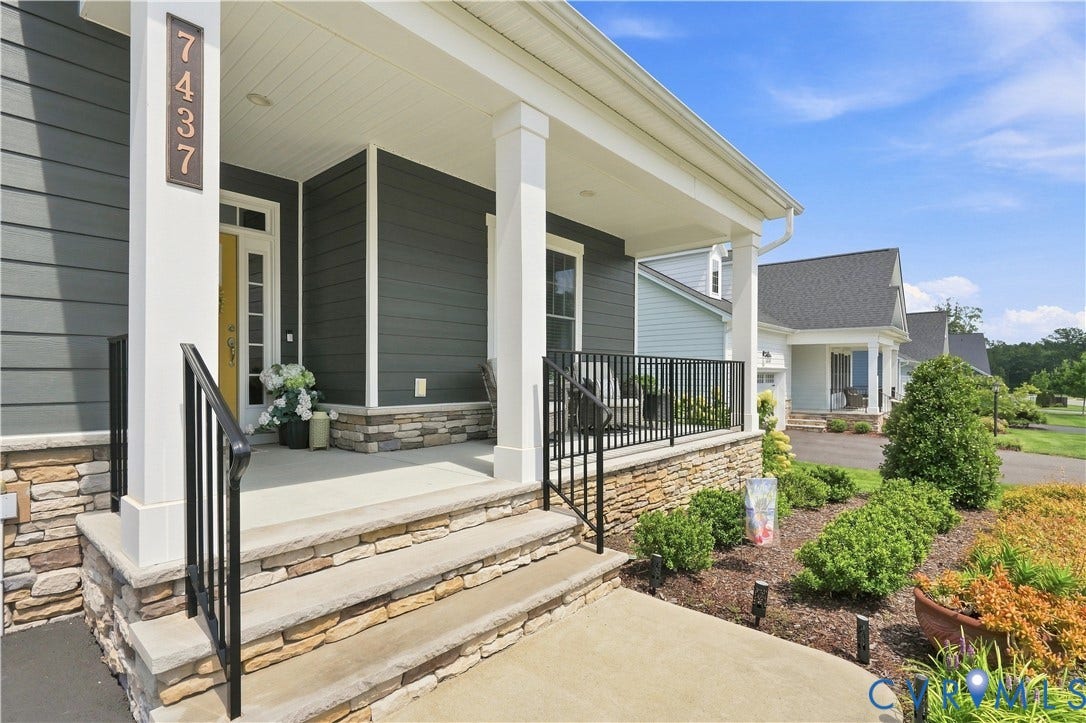 7437 Aldeby Street, Glen Allen, VA 23059 Stone-clad foundation with a covered porch, white columns, and wrought-iron railings