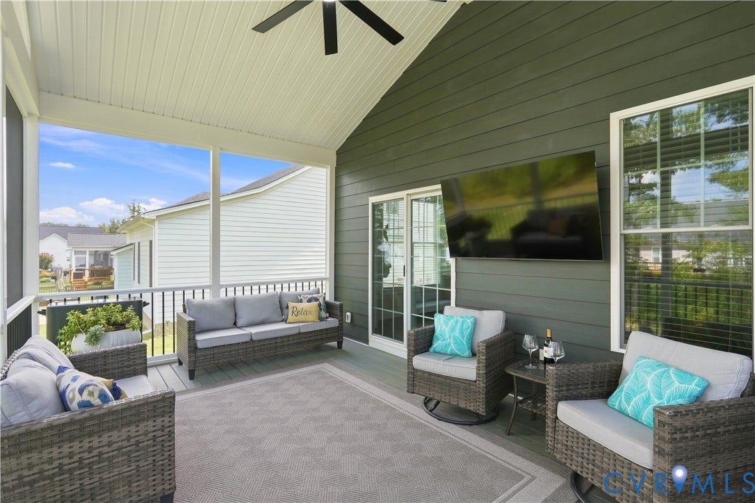 7437 Aldeby Street, Glen Allen, VA 23059 Screened porch with a vaulted ceiling, ceiling fan, sliding glass door, and a wall-mounted television