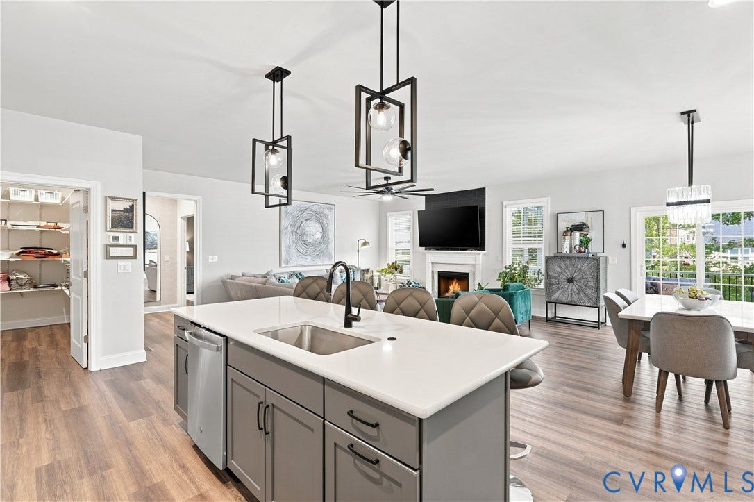 7437 Aldeby Street, Glen Allen, VA 23059 Kitchen island with sink, gray cabinetry, and white countertop