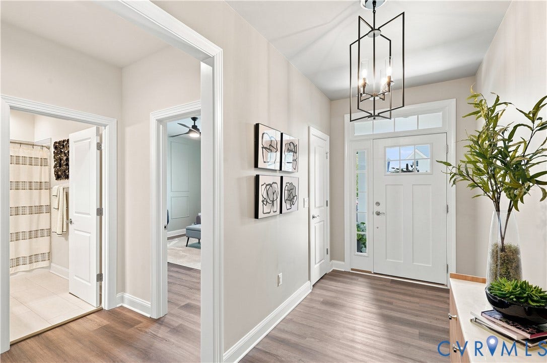 7437 Aldeby Street, Glen Allen, VA 23059 Entryway featuring wood-finish flooring, a contemporary geometric chandelier, and a white paneled front door with sidelights and transom windows