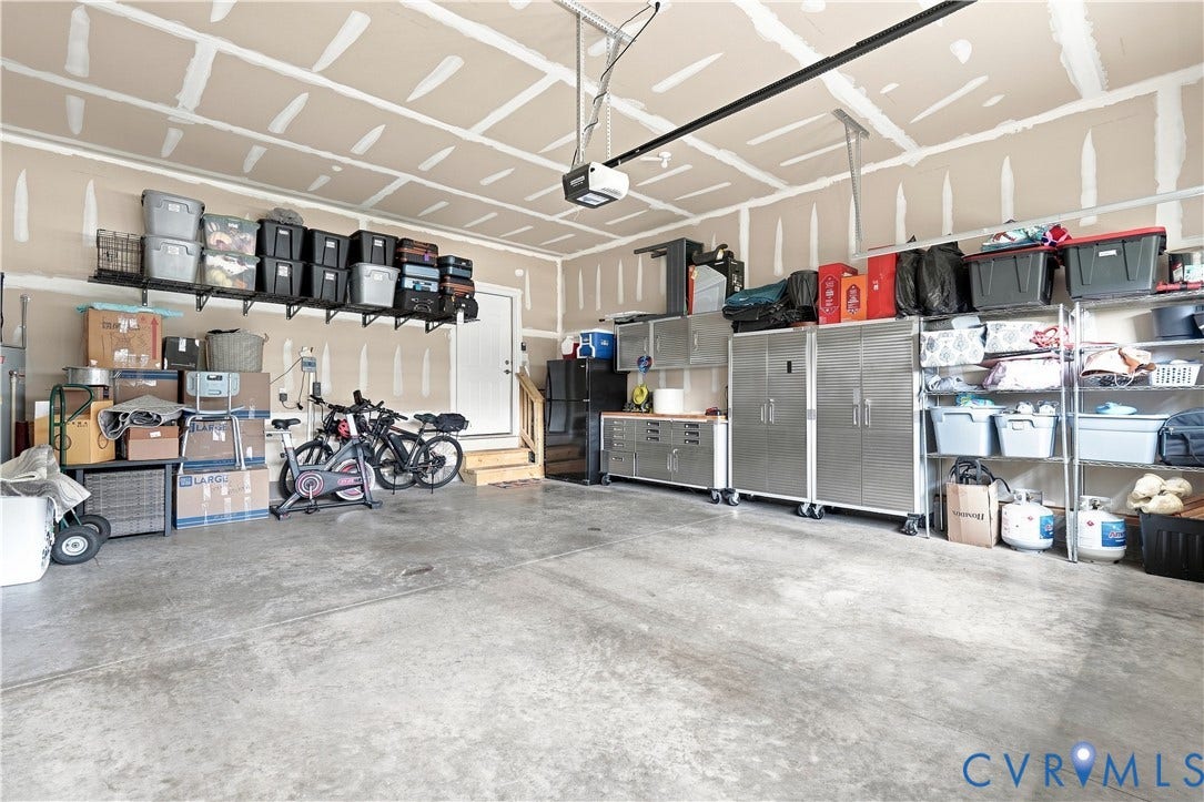 7437 Aldeby Street, Glen Allen, VA 23059 Concrete flooring, wall-mounted shelving, and a garage door opener