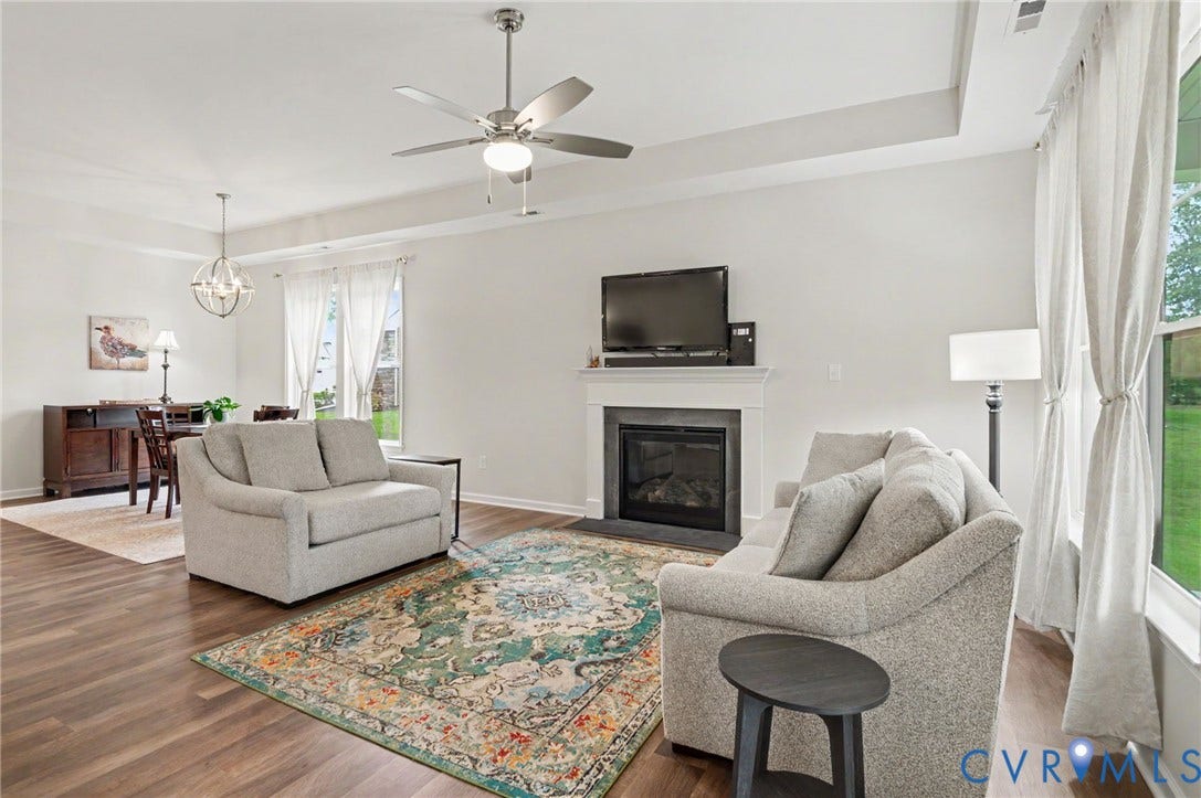 11618 Orchard Falls Circle, Chickahominy Falls, Glen Allen, VA 23059 Open-concept living area featuring wood-finish flooring, a tray ceiling, and a ceiling fan