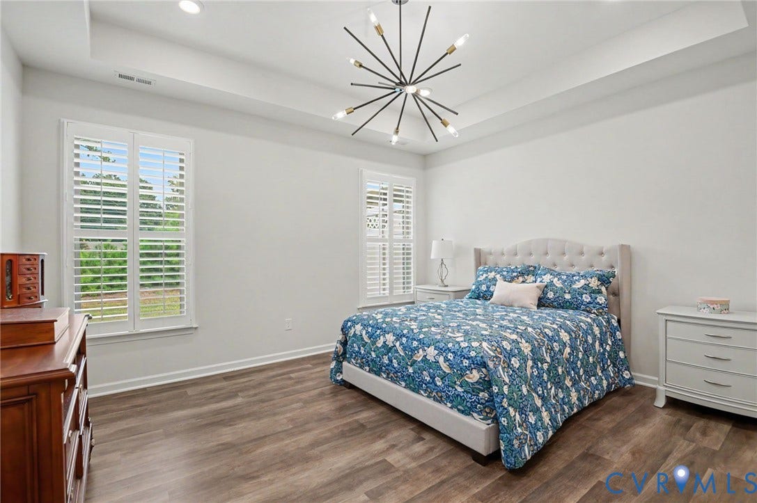 11618 Orchard Falls Circle, Chickahominy Falls, Glen Allen, VA 23059 Tray ceiling with recessed lighting, wood-finish flooring, two windows with plantation shutters, and a modern sputnik chandelier