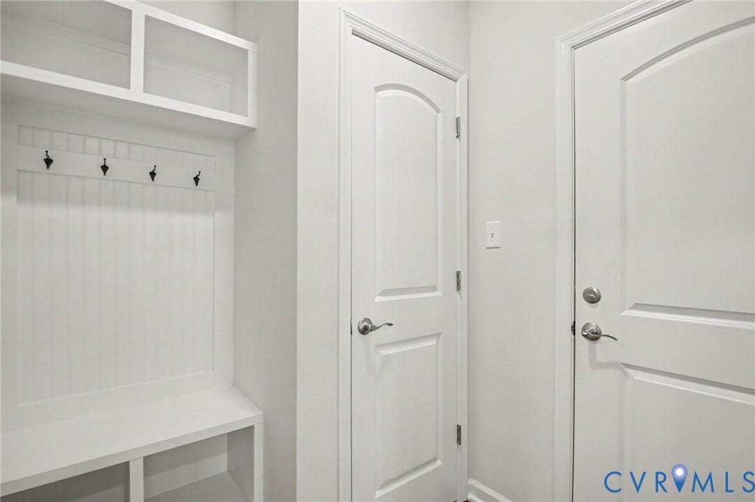 11618 Orchard Falls Circle, Chickahominy Falls, Glen Allen, VA 23059 Built-in mudroom bench with cubbies, upper shelving, beadboard backing, and dark metal coat hooks