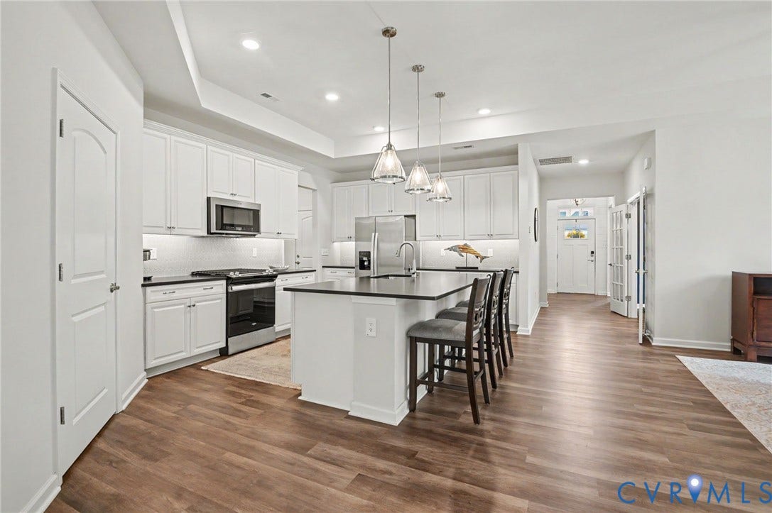11618 Orchard Falls Circle, Chickahominy Falls, Glen Allen, VA 23059 Open-concept kitchen featuring white cabinetry, stainless steel appliances, dark countertops, and wood-finish flooring