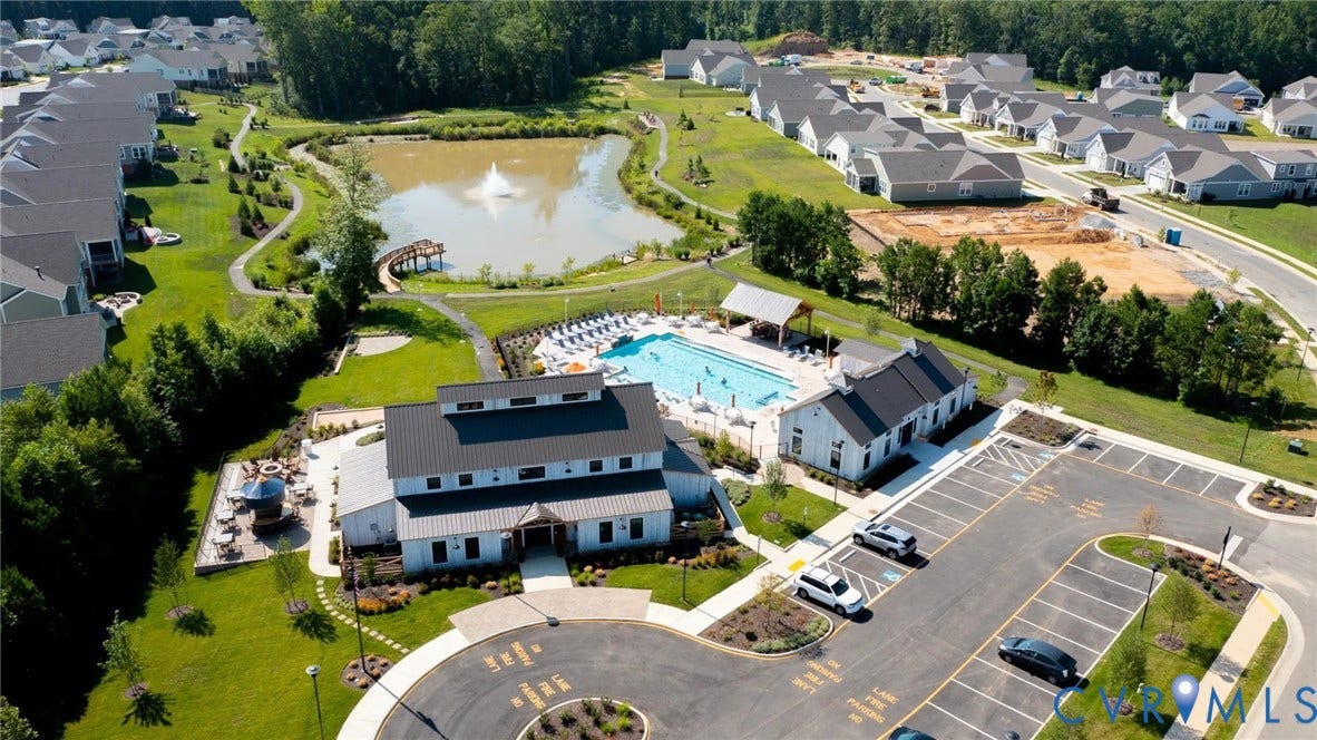 11618 Orchard Falls Circle, Chickahominy Falls, Glen Allen, VA 23059 Community amenities featuring a central pond with fountain, paved walking paths, an outdoor swimming pool, and a clubhouse with exterior lounge areas