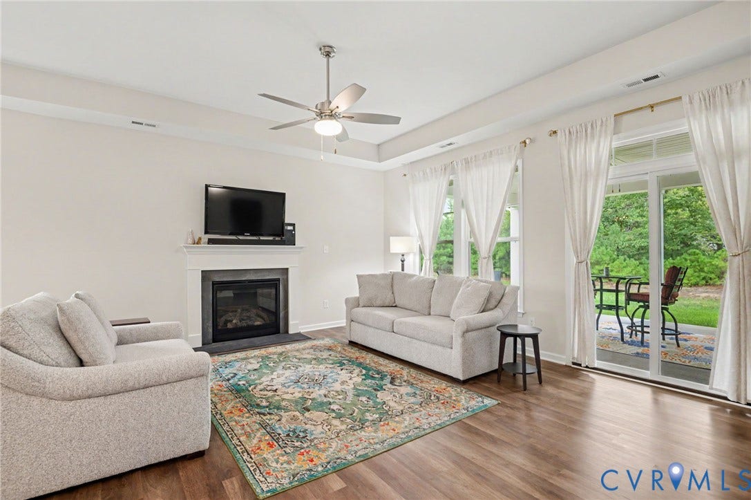 11618 Orchard Falls Circle, Chickahominy Falls, Glen Allen, VA 23059 Wood-finish flooring, ceiling fan, fireplace with mantel, sliding glass door to patio, and crown molding