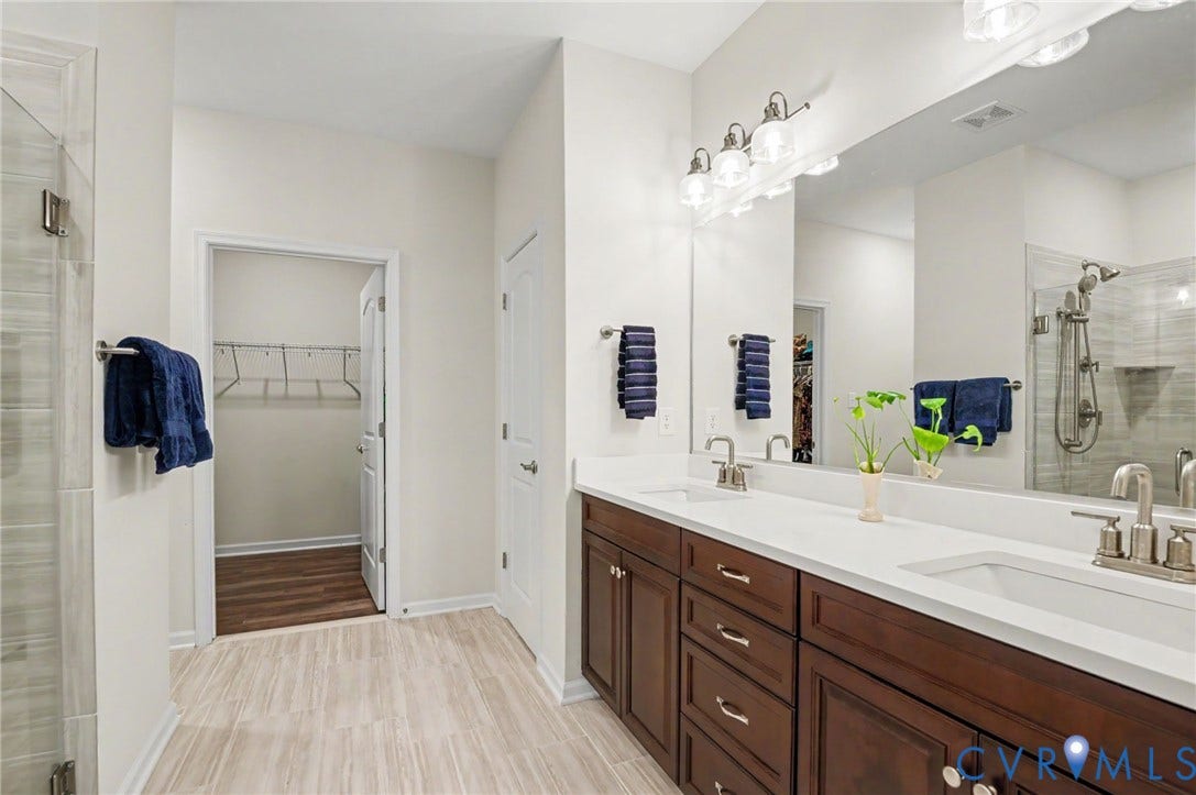 11618 Orchard Falls Circle, Chickahominy Falls, Glen Allen, VA 23059 Dual vanity with white countertops, dark wood cabinetry, and brushed nickel fixtures