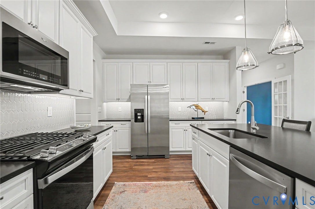 11618 Orchard Falls Circle, Chickahominy Falls, Glen Allen, VA 23059 Kitchen featuring white cabinetry, stainless steel appliances, dark countertops, and wood-finish flooring