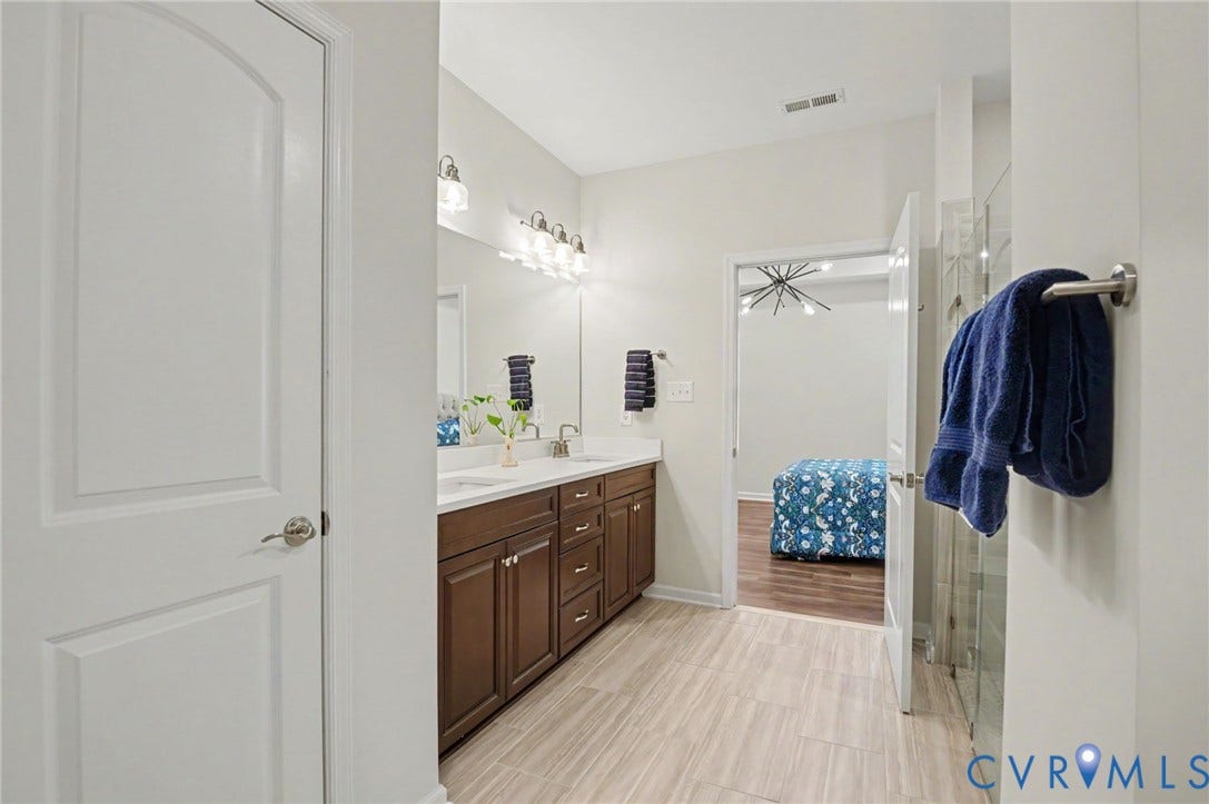 11618 Orchard Falls Circle, Chickahominy Falls, Glen Allen, VA 23059 Dual vanity with ample storage, contemporary light fixtures, and a glass-enclosed shower